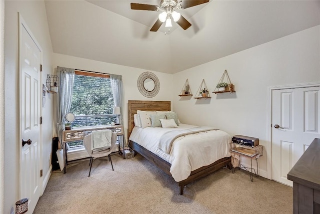 bedroom featuring light colored carpet, a ceiling fan, baseboards, and vaulted ceiling