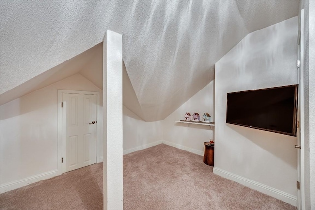 bonus room featuring carpet floors and vaulted ceiling