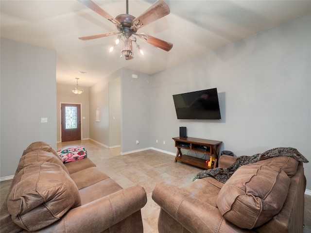 living room featuring baseboards and a ceiling fan