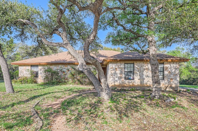 ranch-style house with stone siding