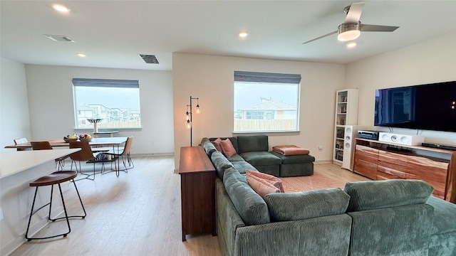 living room with recessed lighting, baseboards, visible vents, and light wood-style flooring
