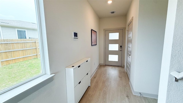 entryway featuring baseboards, light wood-style flooring, and visible vents