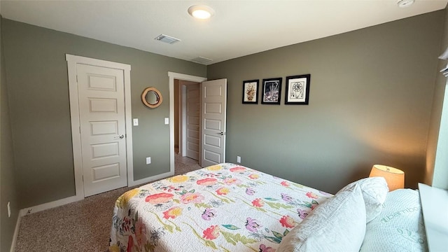 carpeted bedroom with baseboards and visible vents