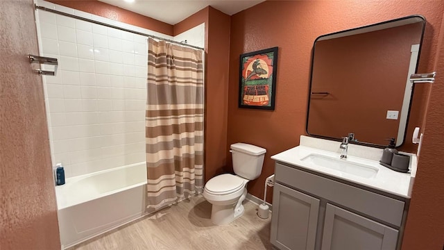 full bath featuring a textured wall, shower / bath combo, vanity, toilet, and wood finished floors