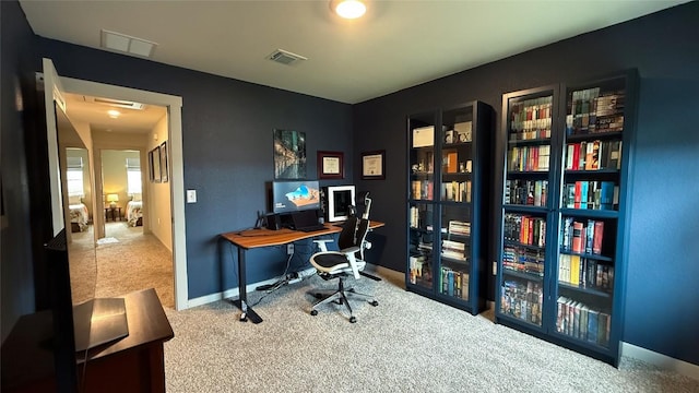 home office featuring visible vents, carpet, and baseboards