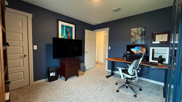 carpeted office space featuring baseboards and visible vents