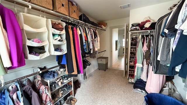 spacious closet featuring carpet and visible vents
