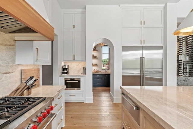 1016 Ferguson Mill Rd, Salado, TX 76571 - kitchen featuring light wood-style flooring, custom exhaust hood, light stone countertops, and high quality appliances