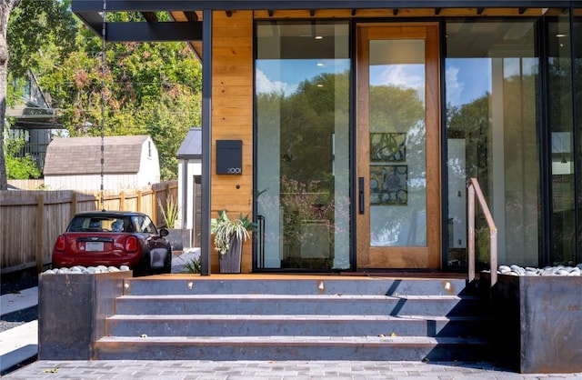 entrance to property featuring fence