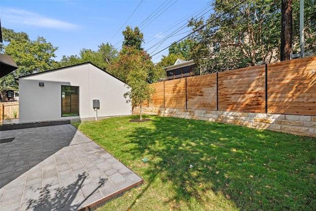 view of yard with a fenced backyard and a patio