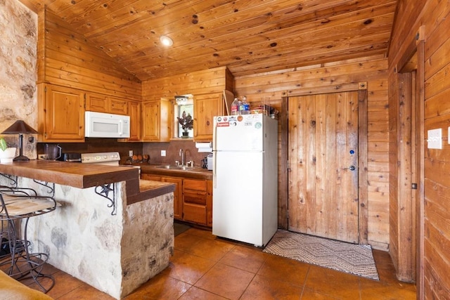 8100 Kuhn Dr, Austin, TX 78736 - kitchen featuring wood walls, a peninsula, white appliances, wooden ceiling, and a sink