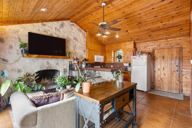 8100 Kuhn Dr, Austin, TX 78736 - tiled living room with ceiling fan, a fireplace, wood walls, wooden ceiling, and vaulted ceiling with beams