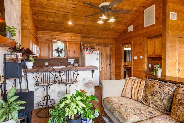 8100 Kuhn Dr, Austin, TX 78736 - living room featuring visible vents, wood ceiling, lofted ceiling, and wooden walls