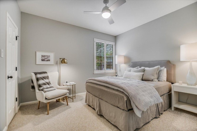 bedroom featuring a ceiling fan, baseboards, and light carpet