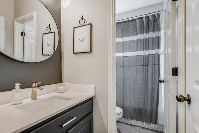 bathroom with toilet, tile patterned flooring, and vanity