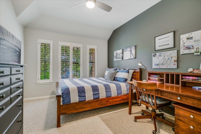 carpeted bedroom with a ceiling fan, baseboards, and vaulted ceiling