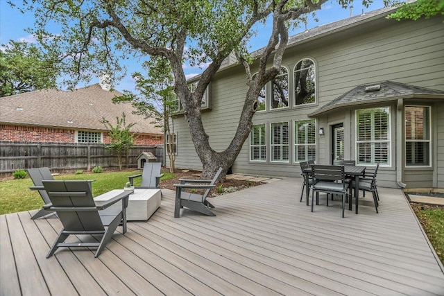 wooden deck with fence and outdoor dining area