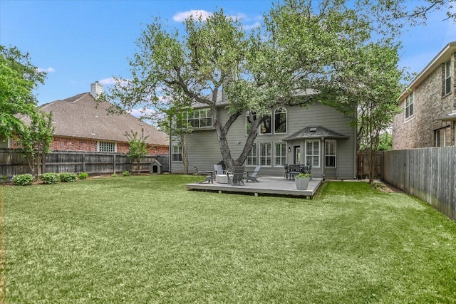 rear view of house with a lawn, a fenced backyard, and a wooden deck