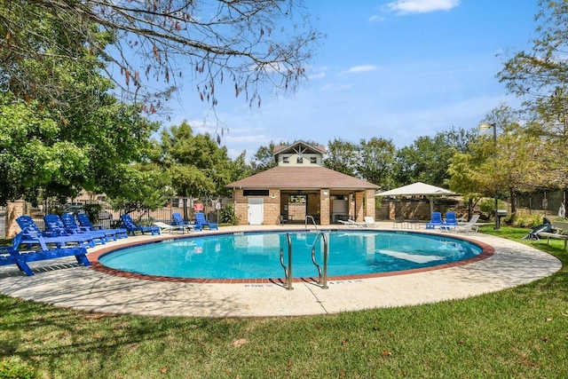 pool with fence and a patio