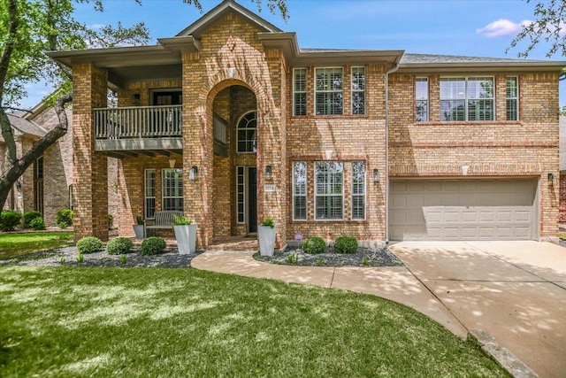 view of front of home featuring brick siding, a garage, a front lawn, and a balcony