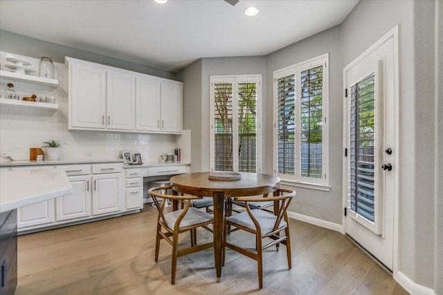 dining space featuring recessed lighting, baseboards, and light wood finished floors