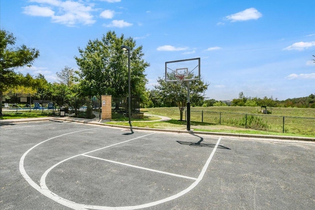 view of basketball court featuring fence and community basketball court
