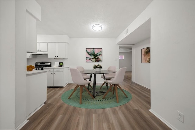 101 E 33rd St Unit 104, Austin, TX 78705 - dining area with a textured ceiling, baseboards, wood finished floors, and visible vents