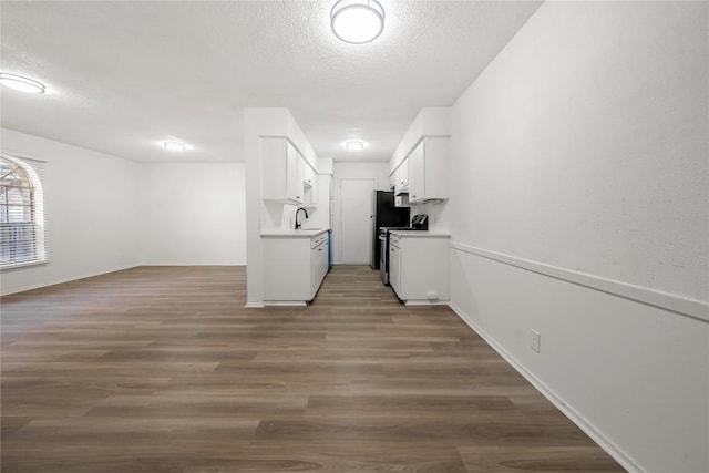 101 E 33rd St Unit 104, Austin, TX 78705 - interior space with white cabinets, a textured ceiling, a sink, and light countertops
