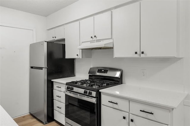 101 E 33rd St Unit 104, Austin, TX 78705 - kitchen featuring appliances with stainless steel finishes, white cabinets, backsplash, and under cabinet range hood