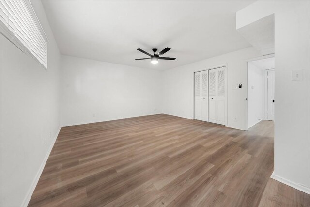 101 E 33rd St Unit 104, Austin, TX 78705 - unfurnished bedroom with baseboards, ceiling fan, wood finished floors, and a closet