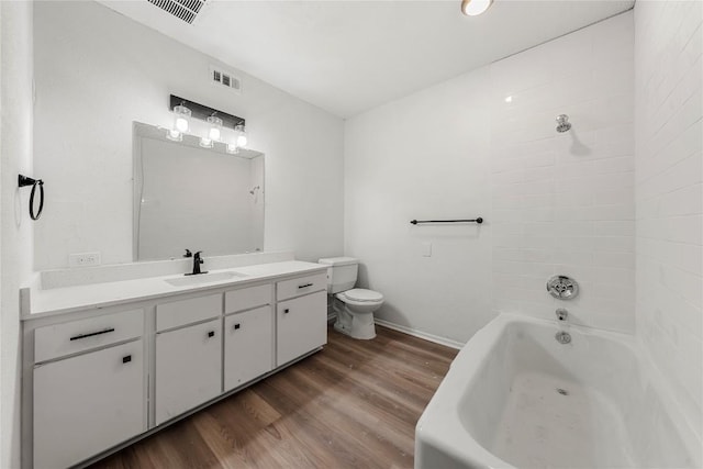 101 E 33rd St Unit 104, Austin, TX 78705 - full bathroom with visible vents, baseboards, wood finished floors, and vanity
