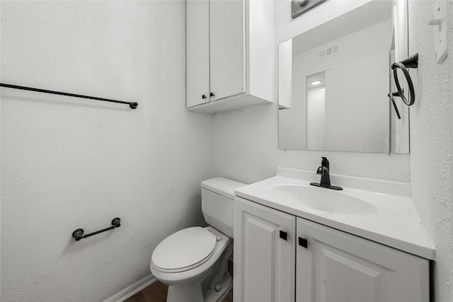 101 E 33rd St Unit 104, Austin, TX 78705 - bathroom with toilet, visible vents, wood finished floors, and vanity