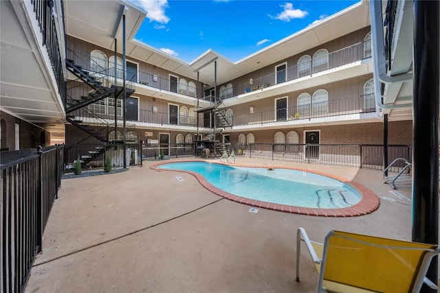101 E 33rd St Unit 104, Austin, TX 78705 - community pool featuring a patio area, fence, and stairway