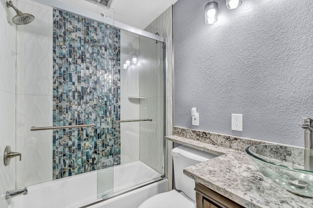721 Fawn, Horseshoe Bay, TX 78657 - full bathroom featuring combined bath / shower with glass door, vanity, and a textured wall