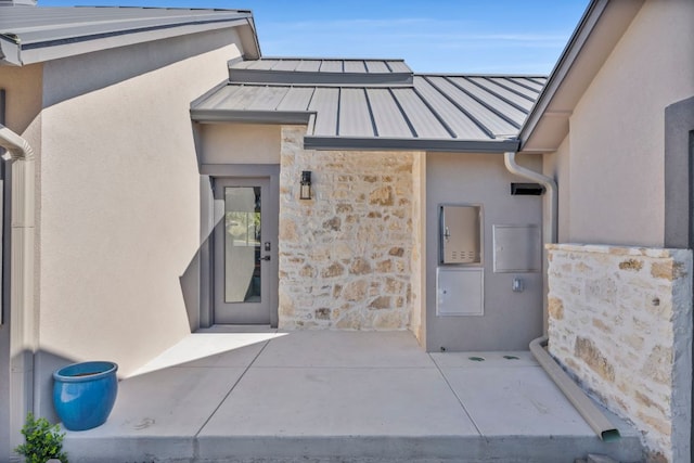 721 Fawn, Horseshoe Bay, TX 78657 - doorway to property with a standing seam roof, stone siding, a metal roof, and stucco siding