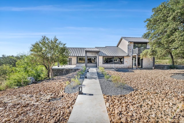 721 Fawn, Horseshoe Bay, TX 78657 - view of front of home with a standing seam roof, a metal roof, stone siding, and a balcony