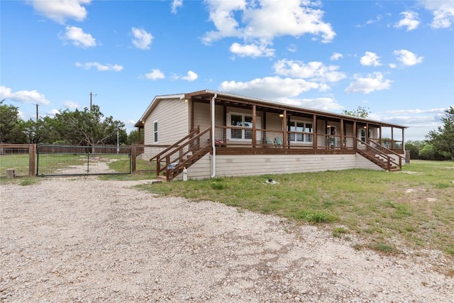 view of front of home with a porch, fence, a gate, and stairs