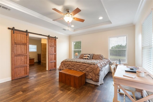 bedroom featuring ornamental molding, dark wood finished floors, a barn door, and visible vents