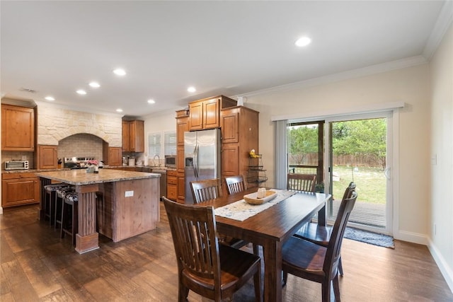 dining room featuring recessed lighting, ornamental molding, and dark wood-style floors