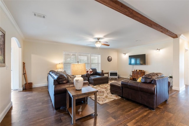 living room with visible vents, ornamental molding, ceiling fan, arched walkways, and dark wood finished floors
