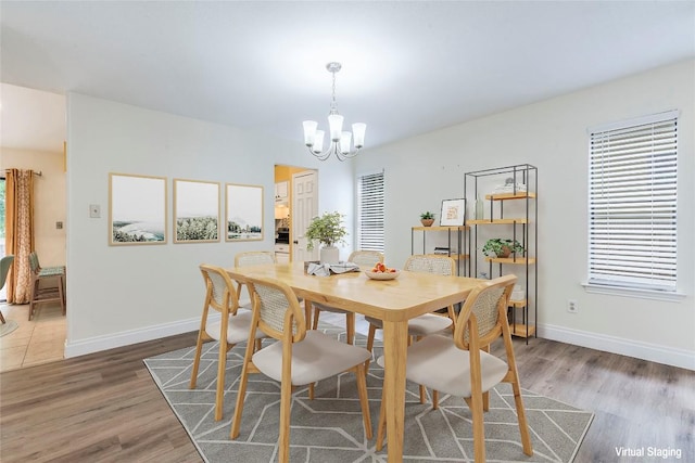 13109 Marble Falls Cv, Austin, TX 78729 - dining room featuring a chandelier and wood finished floors