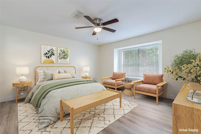 bedroom with baseboards, a ceiling fan, light wood finished floors, and visible vents