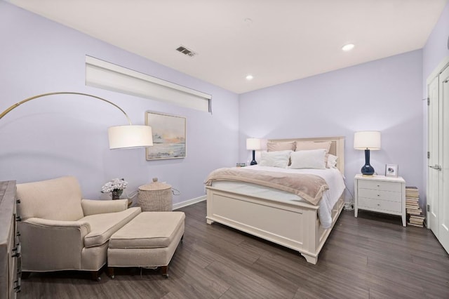 bedroom with dark wood-style flooring, baseboards, and visible vents