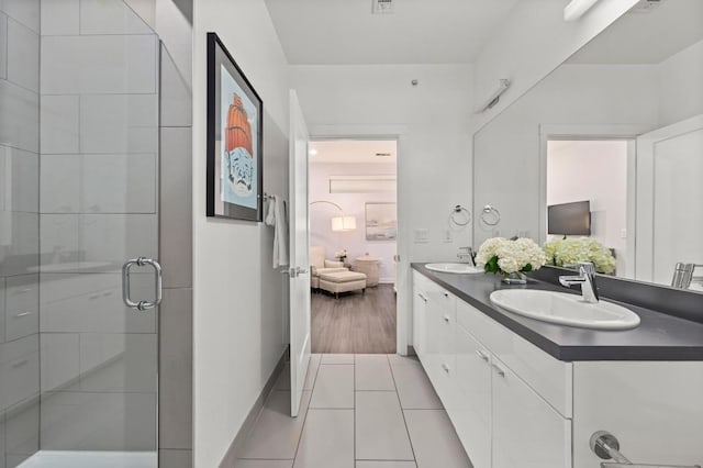 4361 S Congress Ave Unit 427, Austin, TX 78745 - ensuite bathroom with double vanity, a stall shower, and tile patterned flooring