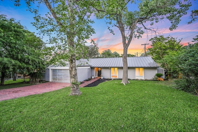 3514 Lakeland Dr, Austin, TX 78731 - view of front of property with a garage, a lawn, metal roof, decorative driveway, and a standing seam roof