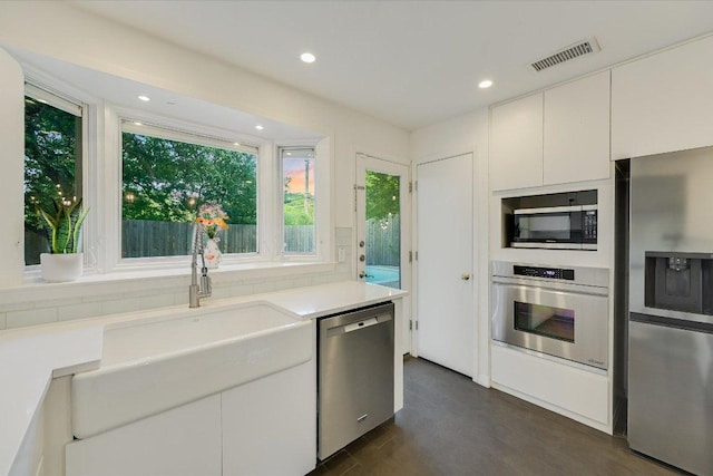 3514 Lakeland Dr, Austin, TX 78731 - kitchen featuring stainless steel appliances, light countertops, white cabinetry, recessed lighting, and dark wood-style floors