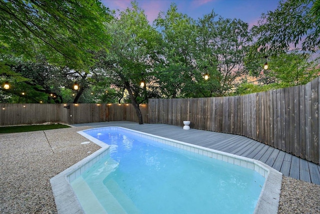 3514 Lakeland Dr, Austin, TX 78731 - pool at dusk with a fenced backyard and a wooden deck