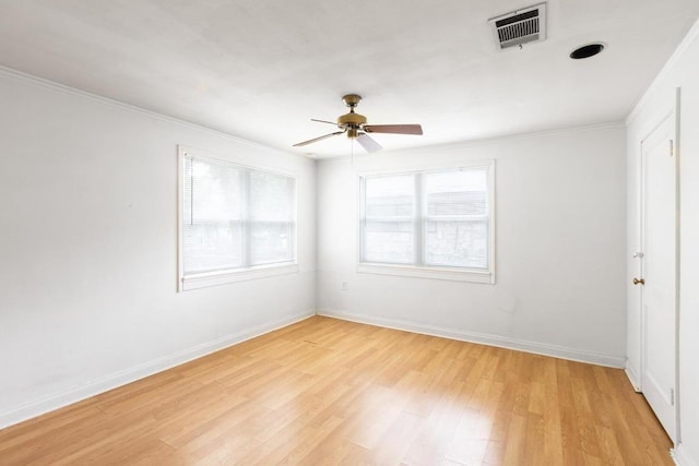 unfurnished bedroom with crown molding, light wood finished floors, a ceiling fan, baseboards, and visible vents