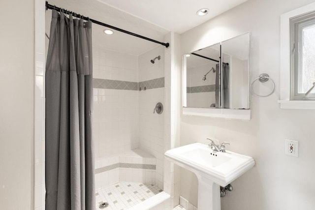 full bathroom with recessed lighting, a shower stall, and a sink