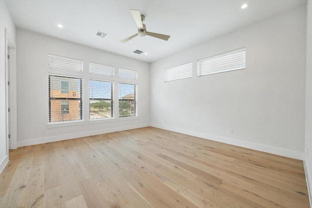 unfurnished room featuring baseboards, ceiling fan, light wood-type flooring, and visible vents